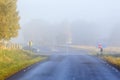 Fog at a crossroads on a country road Royalty Free Stock Photo