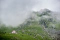 Fog descends to mountains in valley of Fagaras Mountains