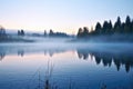 fog drifting over a peaceful lake at dawn Royalty Free Stock Photo