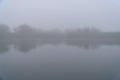 Fog in the early morning on a small lake Royalty Free Stock Photo