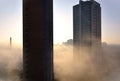 The fog enveloping commercial buildings and the innovation arch in the Colinas garden in the morning in the city