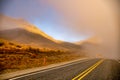 Fog in the extreme dry desert terrain of Lindis Mountain Pass in New Zealand