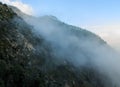 The fog goes up covering the mountains Royalty Free Stock Photo