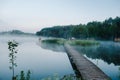 Fog, grass, trees against the backdrop of lakes and nature. Fishing background. Misty morning. nature. Wild areas. bridge over the Royalty Free Stock Photo