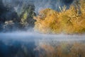 Fog hovering over river early morning at sunrise Royalty Free Stock Photo