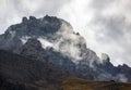 Fog, low clouds and gusty wind in the mountains with rocky terrain