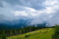 Fog and low clouds near the Transalpina serpentines road DN67C. This is one of the most beautiful alpine routes in Romania Royalty Free Stock Photo
