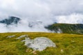 Fog and low clouds over mountains near Transalpina road DN67C. This is one of the most beautiful alpine routes in Romania Royalty Free Stock Photo