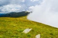 Fog and low clouds over the Transalpina serpentines road DN67C. This is one of the most beautiful alpine routes in Romania Royalty Free Stock Photo