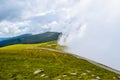 Fog and low clouds over the Transalpina serpentines road DN67C. This is one of the most beautiful alpine routes in Romania Royalty Free Stock Photo