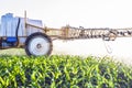 fog from micro fertilizers sprayed with a trailed sprayer on the field of maize