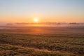 Fog on misty fields at sunrise. The rising sun over the fields in Central Europe Royalty Free Stock Photo