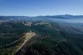 Fog over the forest and the road, panoramic view of the autumn pine forest. View from above. Royalty Free Stock Photo
