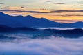 Fog over mountain and forest on sunrise Royalty Free Stock Photo