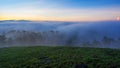 Fog over mountain and forest on sunrise at Da Lat, Vietnam Royalty Free Stock Photo