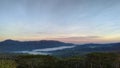 Fog over mountain with green trees during sunrise in Letefoho, Timor-Leste. Royalty Free Stock Photo