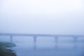 Fog over the river, dawn, Bridge reflection Bridge in the fog