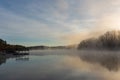 Fog rises by a dock on the surface of the water at sunrise in winter on Lake Lanier in Georgia, USA Royalty Free Stock Photo