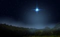 Fog is rising over the night forest. Bright star indicates the Nativity of Jesus Christ in the starry sky Royalty Free Stock Photo