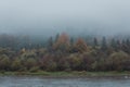 Fog on the river in autumn mountains. Frosty morning in mountains at the riverside. Tranquil autumn landscape with river Royalty Free Stock Photo