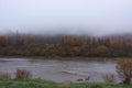 Fog on the river in autumn mountains. Frosty morning in mountains at the riverside. Tranquil autumn landscape with river Royalty Free Stock Photo