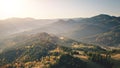 Fog sunrise at mountain village aerial. Autumn nobody nature landscape. Green spruce, leaf forest Royalty Free Stock Photo