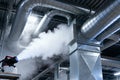 Industrial fogging system spraying disinfectant in a large commercial building Royalty Free Stock Photo