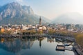 Foggy aerial sunrise cityscape of Lecco town on spring day. Picturesque waterfront of Lecco town located between famous Lake Como