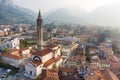 Foggy aerial sunrise cityscape of Lecco town on spring day. Picturesque waterfront of Lecco town located between famous Lake Como