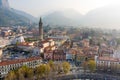 Foggy aerial sunrise cityscape of Lecco town on spring day. Picturesque waterfront of Lecco town located between famous Lake Como