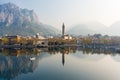 Foggy aerial sunrise cityscape of Lecco town on spring day. Picturesque waterfront of Lecco town located between famous Lake Como