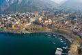 Foggy aerial sunrise cityscape of Lecco town on spring day. Picturesque waterfront of Lecco town located between famous Lake Como