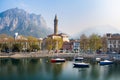 Foggy aerial sunrise cityscape of Lecco town on spring day. Picturesque waterfront of Lecco town located between famous Lake Como