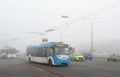 Trolleybuses and cars on the road in heavy fog Royalty Free Stock Photo