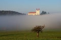 Foggy Autumn Landscape With Church And Lonely Tree Royalty Free Stock Photo