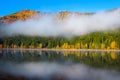 Foggy autumn landscape with Saint Ana lake and colorful forest Royalty Free Stock Photo