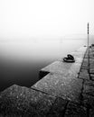 Foggy autumn mood at Vltava river. Detail of riverbank. Black and white atmosphere, Prague, Czech republic Royalty Free Stock Photo