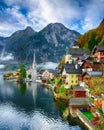 Foggy autumnal sunrise at famous Hallstatt lakeside town reflect Royalty Free Stock Photo