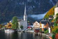 Foggy autumnal sunrise at famous Hallstatt lakeside town reflect Royalty Free Stock Photo