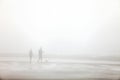 Walking on a lonely Foggy Beach. Royalty Free Stock Photo