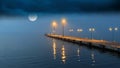 Foggy Night sea harbor street lantern  light blue sea water reflection pier Royalty Free Stock Photo