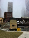 Foggy Chicago evening as elevated `el` train passes over the river and Lake Street bridge. Royalty Free Stock Photo