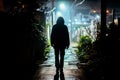 In a foggy city, one person is walking in a dark alley with lights. Royalty Free Stock Photo