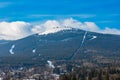 Foggy cloudy landscape seen from long distance of mountain ranges full of snow and giant clouds