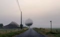 Foggy countryside road sunrise Royalty Free Stock Photo