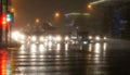 Foggy night crossing with pedestrains, wet asphalt road, street and car lights Royalty Free Stock Photo