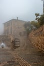 romantic stone house built in a village on a winter day Royalty Free Stock Photo