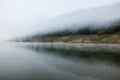 Foggy early morning on the mountain lake