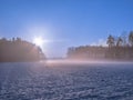 Foggy evening over snow-covered fields. Royalty Free Stock Photo