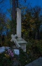 Foggy Graveyard at night. Old Spooky cemetery in moonlight through the trees Royalty Free Stock Photo